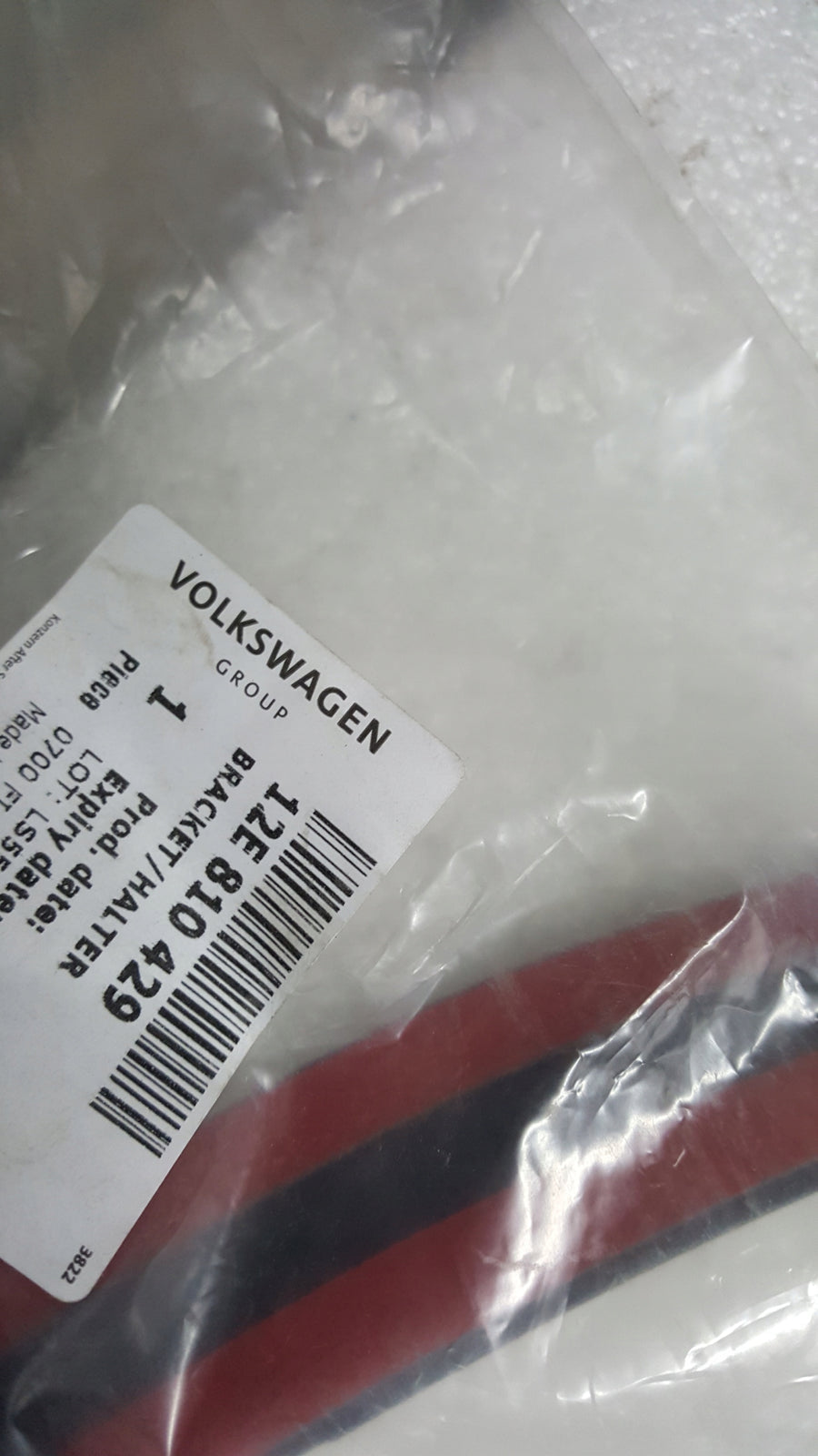 NOWY ORYGINALNY uchwyt nadkola lewy tył VW SKODA SEAT 12E810429